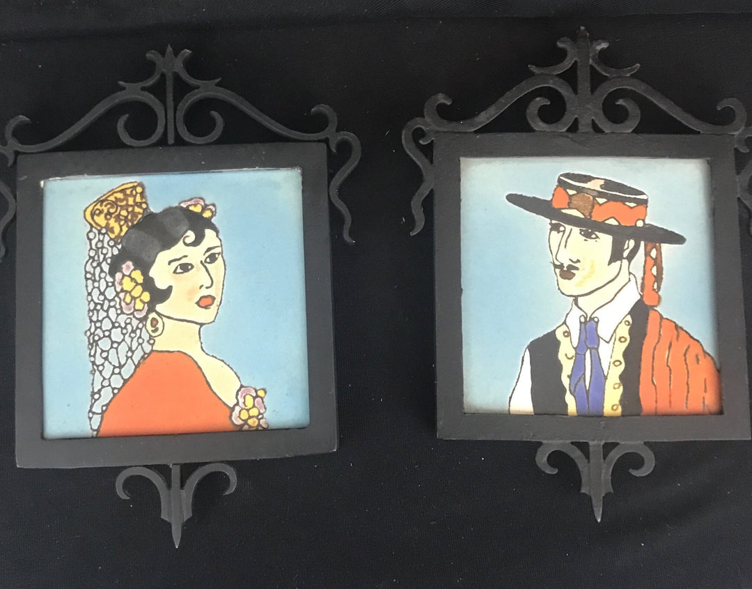 Malibu Pair of Señor and Señorita Tiles, in black cast iron frames.