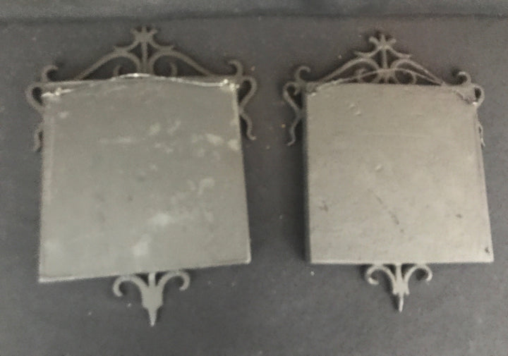 Malibu Pair of Señor and Señorita Tiles, in black cast iron frames.